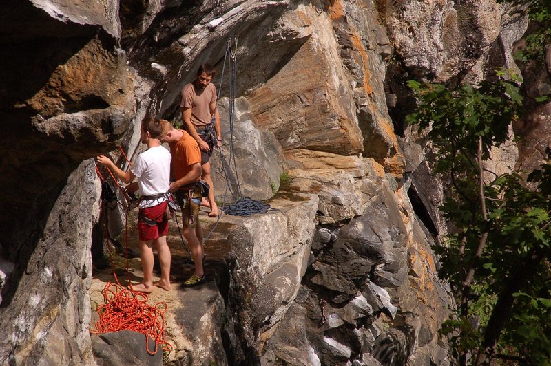 The ledge on top of Tropicana. The rightmost climber is on the Tropicana anchors and the left most is on the anchors for the Predator belay.