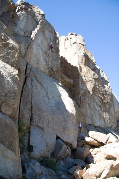 Setting up for the crux on Hit and Run, 5.11b