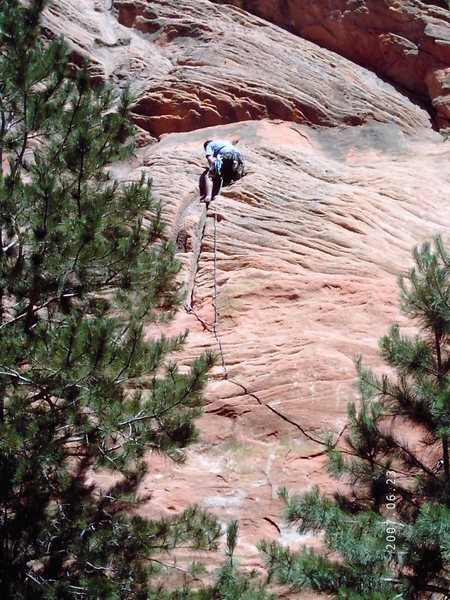 Placing slings on the big eye bolts at the beginning of the climb.