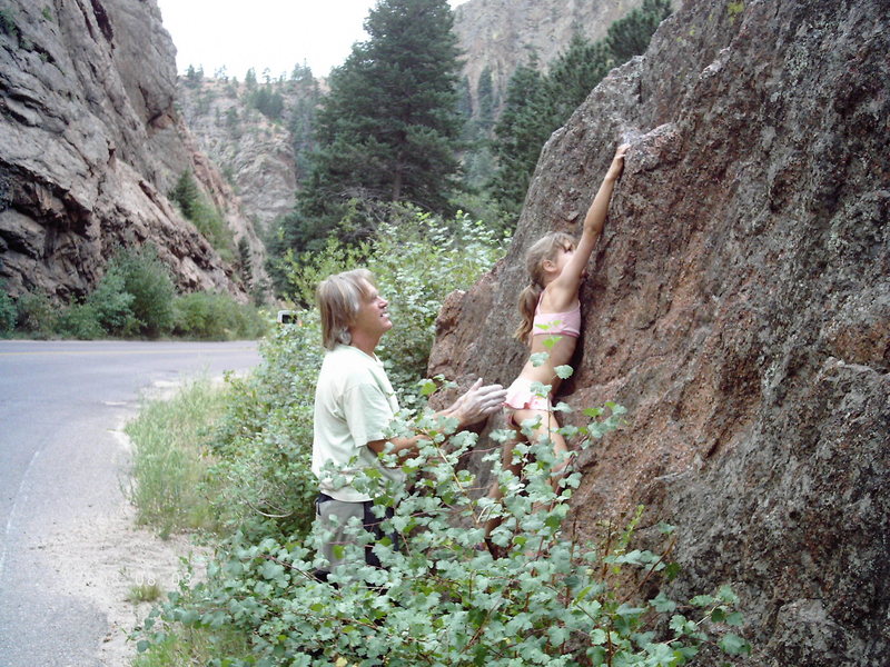 Maya Girl sending her first outdoor boulder problem (V0), being spotted by climbing legend Jimmy Dunn.