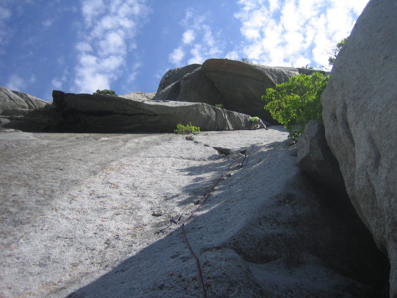 Tyler, past the crux, underclings out the overlap to the finish.