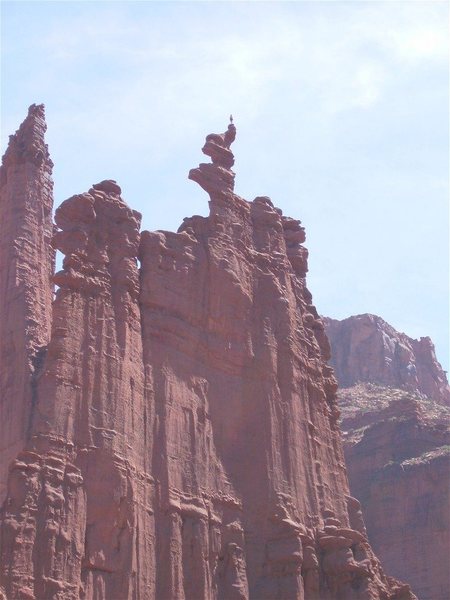 Climber on summit of Ancient Art, as seen from the trail bottom.