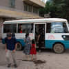 Disembarking from the Kunming bus in Fumin town, headed for the second leg of the trip via horse cart or motorcycle taxi.