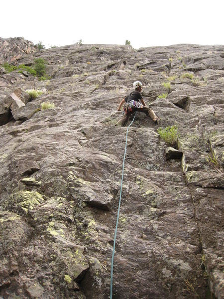 Nick starting up South Park. The second pitch ends at the tree above his head at the skyline.