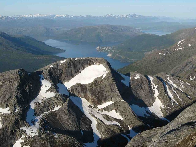 Looking over Elveran to Kjopsvik from the summit of Stetinden.<br>
This entire region is chockfull of excellent mountain destinations. Many of the nearby peaks are of the same fine granite as Stetinden, though a few, like Prestinden, appear much less stable.<br>
Obviously, the northern faces receive much less sunlight, so snowfields remain year-round. Several glaciers lie nearby, also.