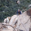 Brett rounding the corner after traversing the roof and nearing the 3rd pitch belay