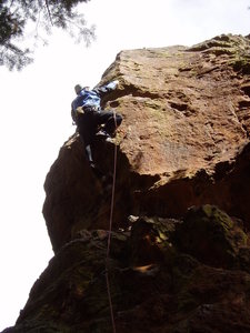 Clipping the last bolt after making the crux move.