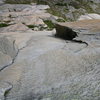 The crux seventh pitch from above, with the flaring chimney, blank traverse, and final crack leading up to the anchor