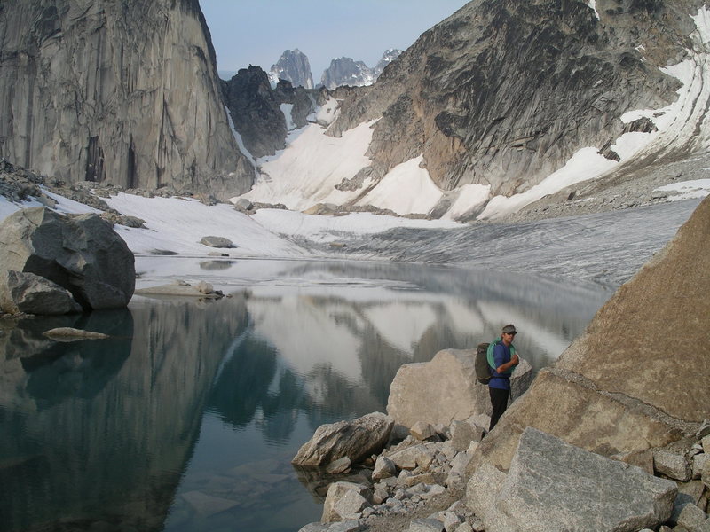 Heading towards the Crescent Spire with the Snowpatch-Bugaboo Col and the tops of the Howsers in the background.