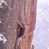 Ted on the final crux moves of the Quickening. Third Millennium and Grand Ole Opry visible to the right.  Photo by Jay Perry.  