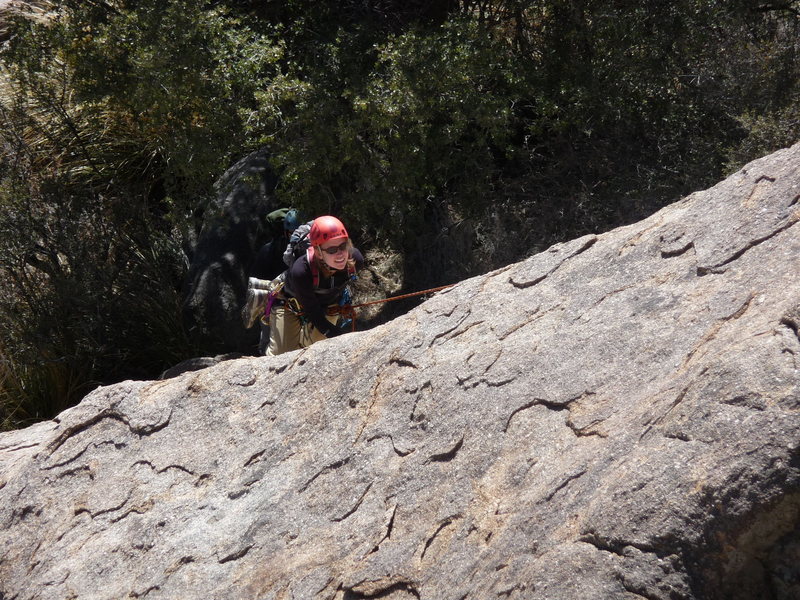 Sarah around the top of the run-out section on the route <em>Winter Solstice</em> (5.6R), <em>Winter Solstice Slab</em>.  None of the rock of the actual route is shown.  Photo is taken via zoom from the top of <em>Upper Dome</em>.