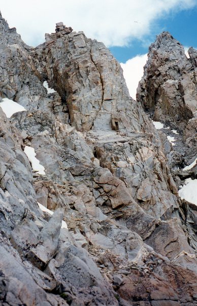 A view of the Southwest Chute on the right leading to the U-Notch.  This photo was taken at the west end of the Catwalk and also shows the gully above the chute that leads to the summit of North Palisade.  Photo taken 21 Aug 95.