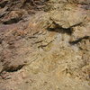 Weathering in the Colorado Mineral Belt near Boulder.  These rocks have been chemically changed by the circulation of hot fluids rising up along very old faults.  While hydrothermal alteration has basically destroyed these rocks from a climbing point of view, other hot-fluid alteration (Adularia:potassium feldspar) accounts for the hard sandstone of the Fountain Formation in El Dorado Canyon. See scanning electron microscope pic of this adularia, infra. Fountain Formation rocks that are not near the Colorado Mineral Belt are poorly cemented and crumbly.