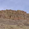 Columnar jointing in basalt. North Table Mt, Golden, CO.  Shown here are 2 flows of Shoshonite, a potassium-rich basalt, probably originating 5 miles north of Golden about 60 million years ago.  One sees at Table Mt, spheroidal weathering, glassy-appearing cooling planes, and vesicles filled with white zeolite minerals.