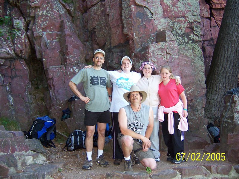 The route is on the face behind the young lady in red.