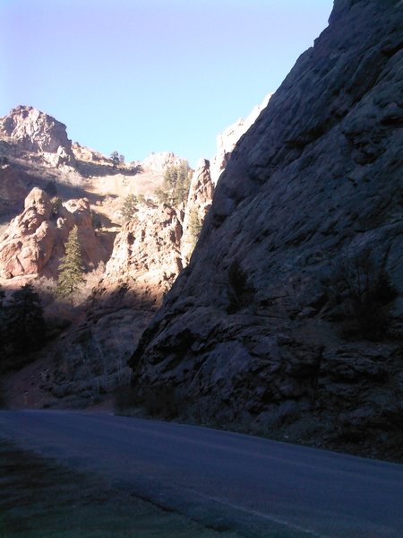 The first view of the spire summit can be seen just left of the shadow line in this photo.  This is taken just before the big turn at Graduation Boulder.