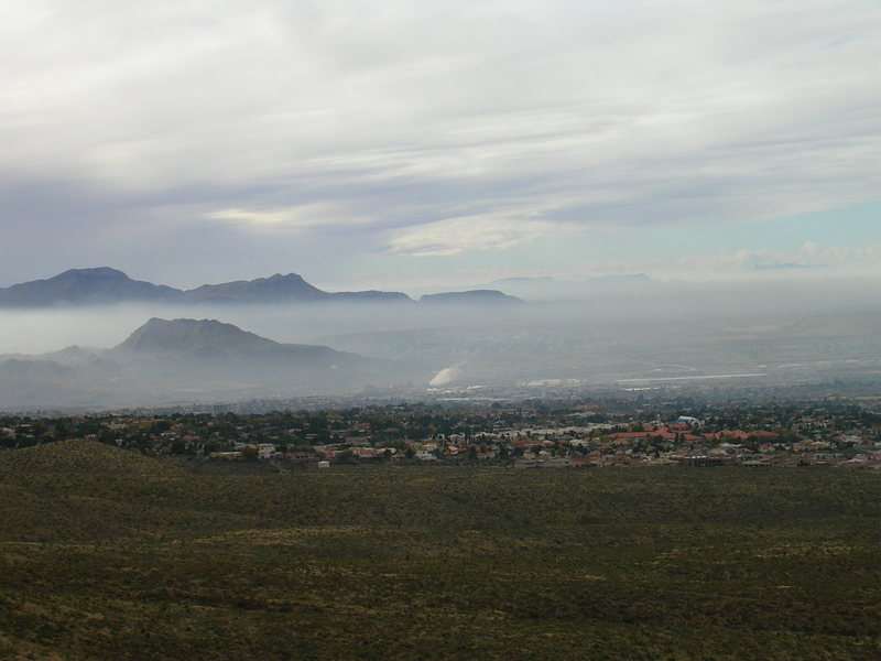 The second bolt on Desperado (5.10+) broke under body weight according to a sign in the ranger station.  <br>
<br>
This photo shows the air pollution in Juarez immediately after a huge rain, so this is a good day.  After observing a  possible relationship between polluted rain from Denver and weaker bolts, I'm hypothesizing that air pollution increases the rate of bolt corrosion at Hueco.     <br>
 