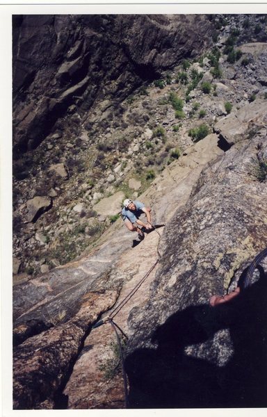 Manteling the "peg flake" on the Peg traverse.  Photo by Josh Janes.