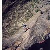 Manteling the "peg flake" on the Peg traverse.  Photo by Josh Janes.