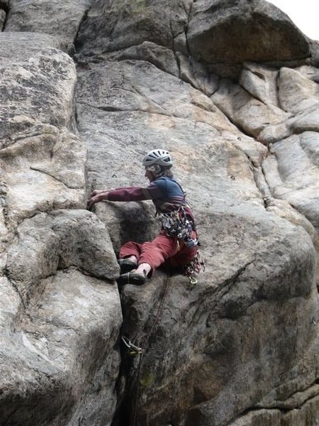 I was a little shaky getting stood up. I had expected the feature to the left to be an incut flake, but it was a slopey instead. So I kept on laybacking. The fourth and final bolt is just above my head. Photo by Ken Parker.