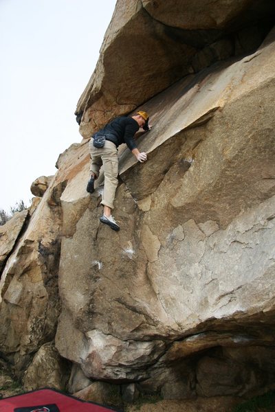 Making the committing high step on Haney Wall, V1