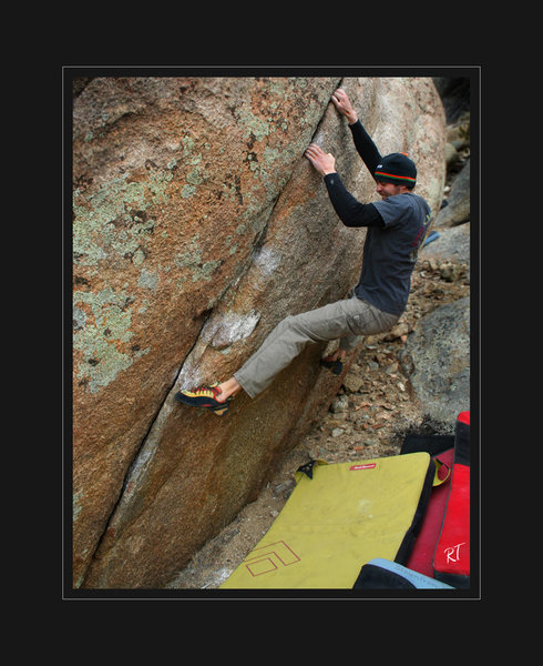 Colby F. marching his fingers into a shallow seam in large 20/25ft boulder.