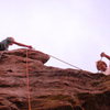 Two monkeys rock climbing