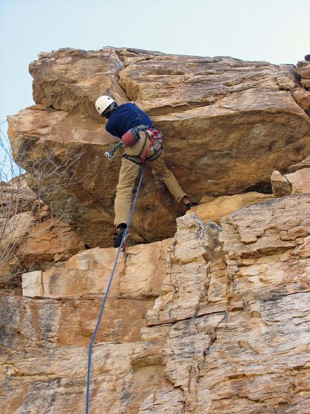 Jamming through the crux roof on the FA of Hooligan.