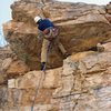 Jamming through the crux roof on the FA of Hooligan.