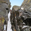 Dougald finishing P2. We did not climb this obvious chimney - it was full of greasey lichen & moss. We moved right 10' to a better choice.