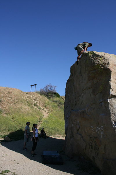 Albert topping out on Boulder 1 as Nathan and Agina watch.