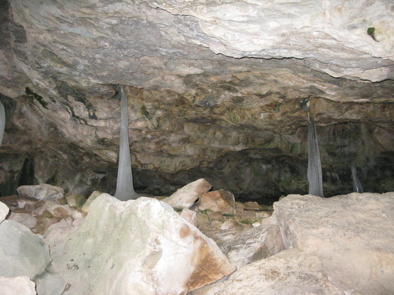 The narrow entrance to spring cave, cool ice stalagmites.