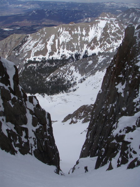 Joe Ryan (builder and CEO of the San Juan Hut System) above the crux while teleing the north face of Sneffels