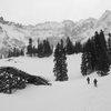 Twyla Gingrich and Greg Tibboel skin past an old mining structure in Alta Lakes