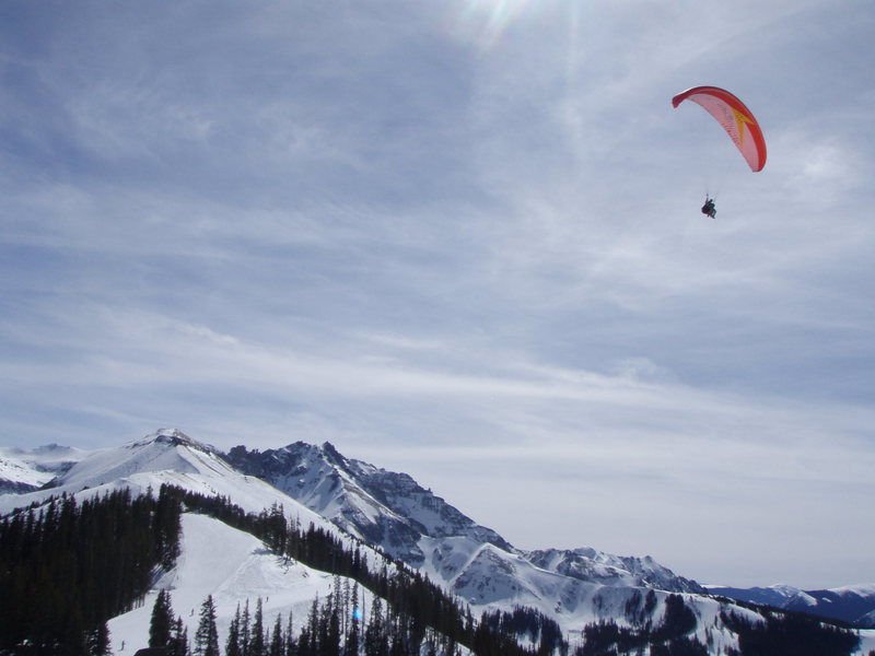 Paraglider with Palymra Pk (13k') in the back at Telluride Ski Resort