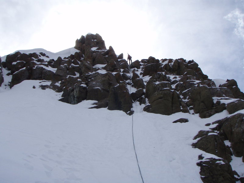 Kelly rapping of the summit block of Sneffels.  I had brought no harness so Joe lowered me with the rope tied about my chest.  