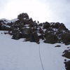 Kelly rapping of the summit block of Sneffels.  I had brought no harness so Joe lowered me with the rope tied about my chest.  