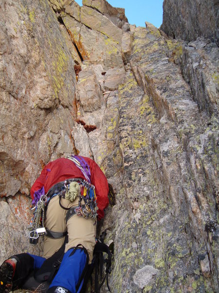 Erik gears up below the cleft chimney.  The pin is halfway up this pitch, below the roof.  Move right at the roof and into the next couloir.  This is P3 and is short.