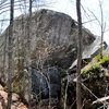 This is the slab boulder as you approach it.  The split in the rock is where the Back Slapper Problems are.  The overhanging face climb on the right chunk is Pit Fall.  Counselor Moon is on the overhang of the left chunk, and The Seamstress is on the left arete.