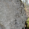 This is the slab on the right side of the Buddha Boulder.  Kris Johnson was the first to climb the slab problem starting from the obvious hold in the center & using a twisted hand-foot match move to the good hold on top.