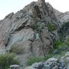 One start is to the right of this arete, up the bushy ledge to a belay location near the end of the ledge.