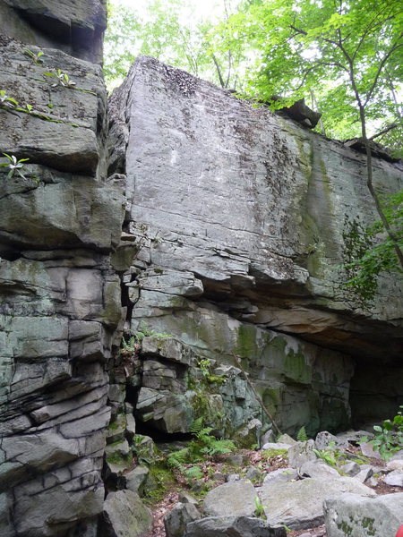 The Brutal Block.  The Face of Reality, 12a, goes up the clean face to the right of the Arete.  The Matrix, 11c, climbs out the roof and then up the right facing corner which is now much cleaner than appears in the photo.