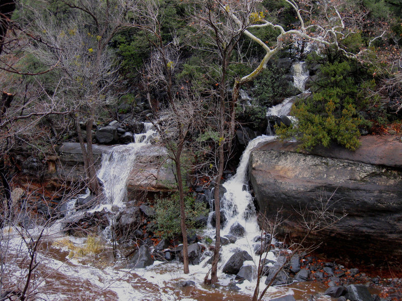 A swollen Oak Creek and the beginning of the approach, spring 09. The left bench of stone leads to the beginning of the uphill section of the approach. Normally these stone benches are dry.