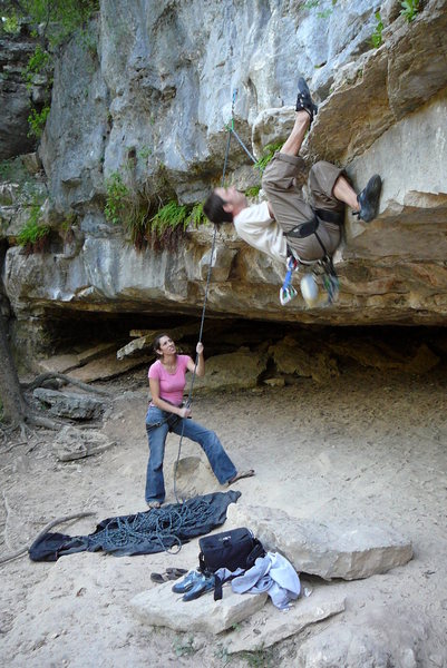 Heel hooking the start on Austin, TX limestone in the Barton Creek Greenbelt (Charlie Don't Surf 5.10d). Girlfriend (Annette) is belaying.