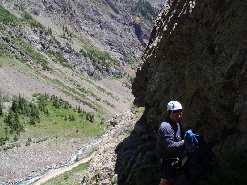 Climb starts from where I'm standing.  The 5.9 is on the other side of the bulge behind Jeff. (Background: Looking down the canyon towards Eureka. The intermittent waterfalls which form the classic ice climb, Stairway to Heaven, can be seen across the valley.)