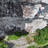 One move above where I described the hanging belay (although it doesn't have to be there, and she obviously didn't belay there).  The route finishes directly to her right.