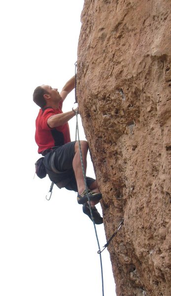 Snagging the crux pocket on the Gym Arete Direct.