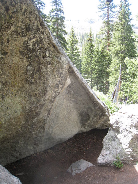 All Dogs Go To Evans climbs the severely overhanging arete, to the prow of the boulder, near the top of Seurat.  Rawhide begins up ADGTE, but turns the lip at the big jug under the roof, then follows the tricky slab to the top.