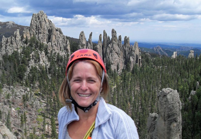 Brenda on the summit of Spire One with the "Picket Fence" in the background.