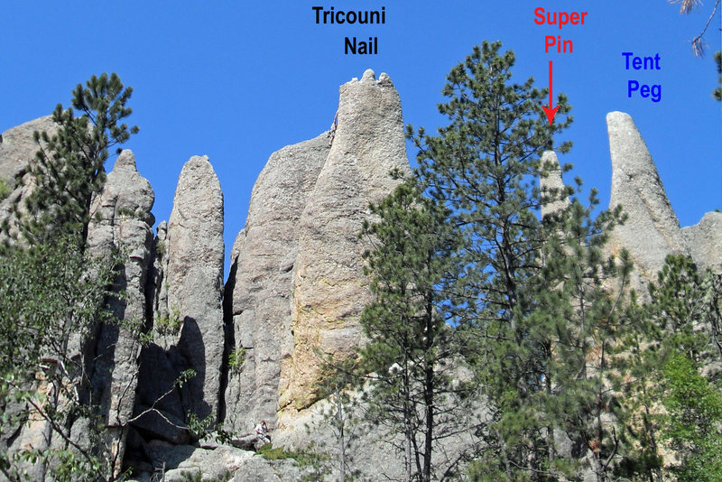 Looking at the Tricouni Nail, Super Pin, and Tent Peg from across the small gully to the east.  A climber can be seen just beneath the summit of the Nail.